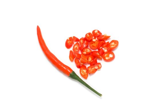 red chili peppers with small slices on white background