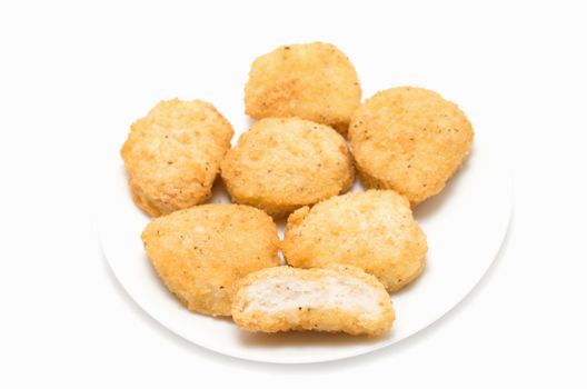 Fried chicken nuggets on a ceramic dish on white background