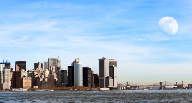 Manhattan cityscape with almost full moon during a sunny day