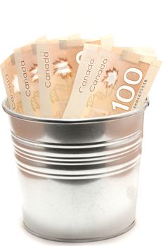 Hundred Canadian dollar bills in an aluminium  pot