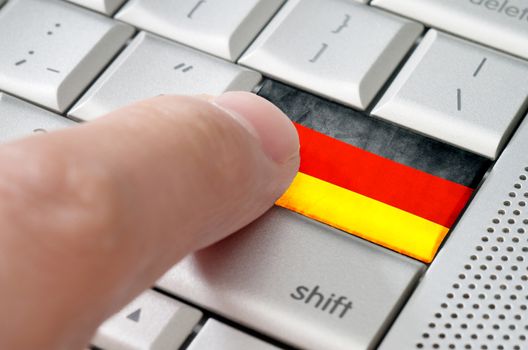 Business concept male finger pressing Germany enter key on metallic keyboard