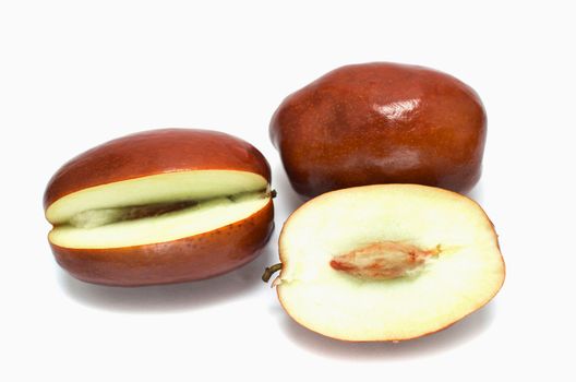 Whole and sliced unabi berries isolated on the white background 