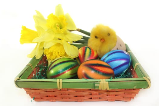 an Easter basket of colorful easter eggs and daffodils