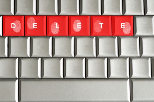 Concept delete spelled on metallic keyboard with fingerprints overlaid