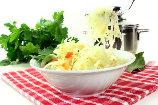 A white bowl with fresh sauerkraut