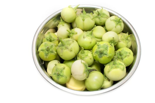 Ripe Asian eggplants; asian round eggplants in a metallic bowl