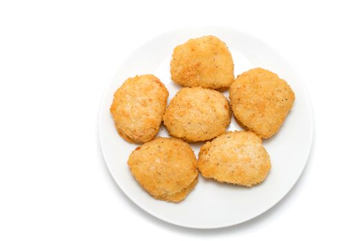 Fried chicken nuggets on a ceramic dish on white background