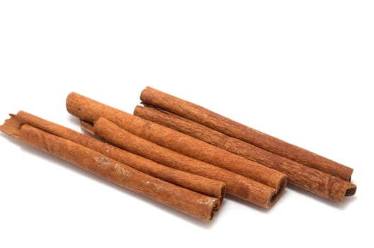 Three cinnamon sticks on white background