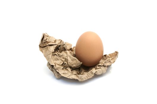 Egg in crumpled wrapping gray paper and white background