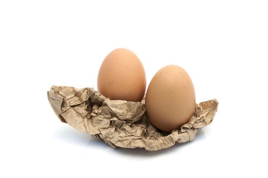 Egg in crumpled wrapping gray paper and white background