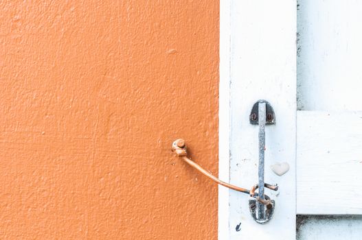 orange wall with a windows and hook