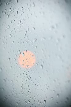 water drop on glass and the lights in the background.