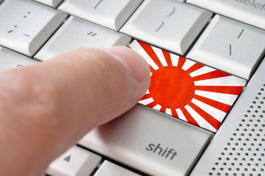 Business concept male finger pressing Japan enter key on metallic keyboard