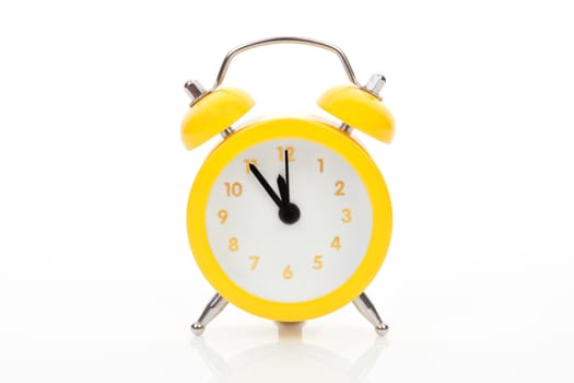 Yellow alarm clock isolated on white background. Just in time concept.