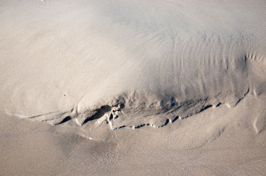 Small natural sand shape on a beach.