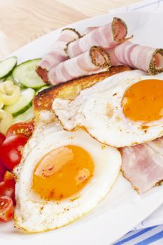 Traditional western breakfast. Fried eggs, ham, toast and fresh vegetable. Tomatoes, cucumber and capsicum. Good morning concept.