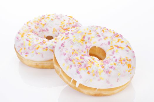 Two luxurious donuts isolated on white background. Culinary sweet desert concept.