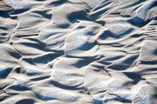 Naturally created heart shapes in wet sand.