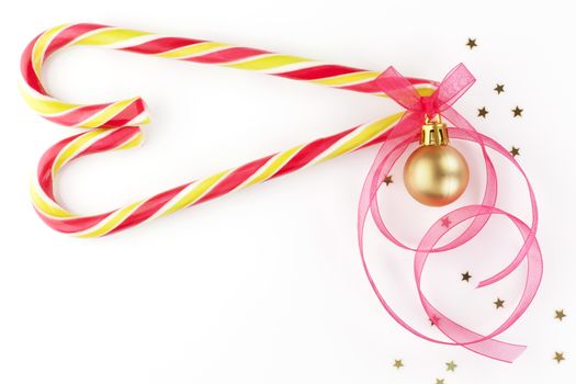 Christmas background with copy space made of candy cane in heart shape, christmas ball and ribbon. Beautiful xmas copy space.