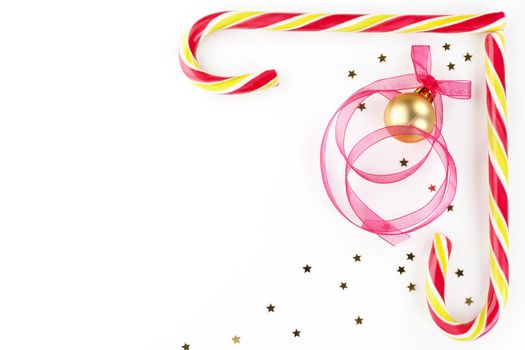 Christmas background with copy space made of candy cane, golden stars, christmas ball and ribbon. Beautiful xmas copy space.