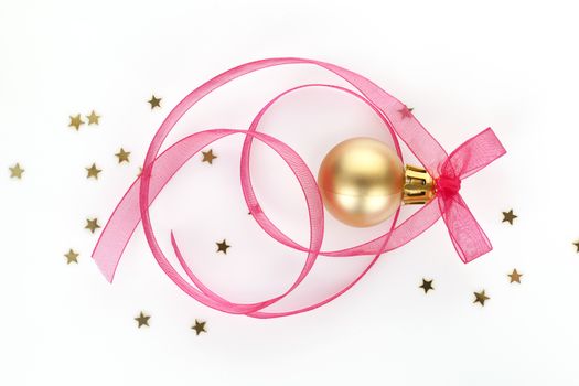 Luxurious xmas still life in gold and pink. Stars, ribbon and golden christmas ball.