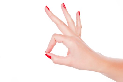 Female hand with red fingernails showing everything is fine isolated on white. 