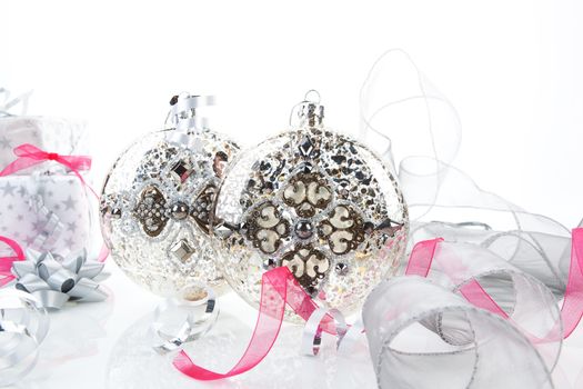 Luxurious christmas vintage decoration with gifts in background. Xmas still life in silver and pink. 