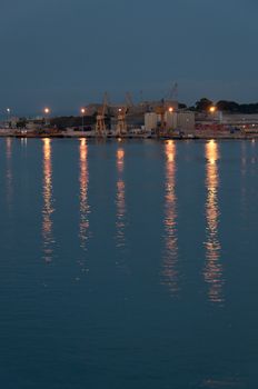 Light reflections from industrial area at daybreak. Majorca, Balearic islands, Spain.