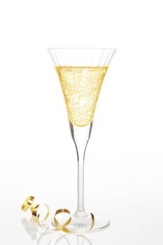 Champagne in glass with golden ribbon isolated on white. Luxury concept.