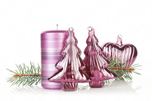 Christmas still life with conifer, xmas tree decoration and purple candle isolated on white.
