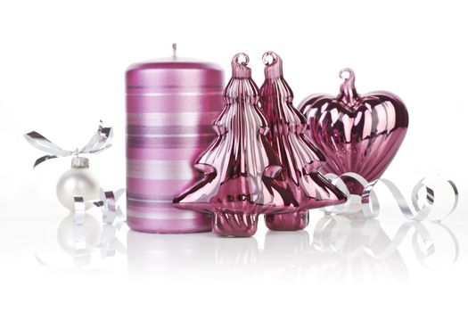 Purple shiny christmas still life with candle, and xmas decoration. Temporary christmas design concept.