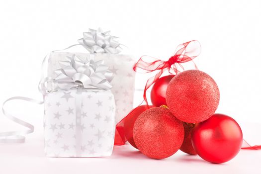 Luxurious christmas background. Red balls and beautifully wrapped presents.