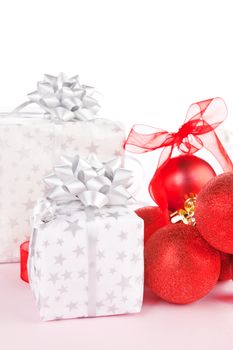 Luxurious christmas background. Red balls and beautifully wrapped presents.