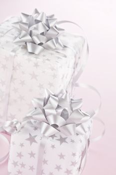 Beautifully wrapped christmas gifts on pink background. Christmas background.