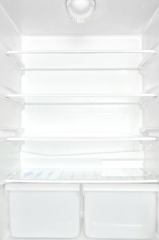 Open empty white refrigerator. Unhealthy eating disorder concept.