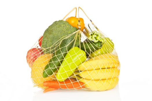 Full grid bag of fresh vegetable and fruits. Colorful healthy eating concept.