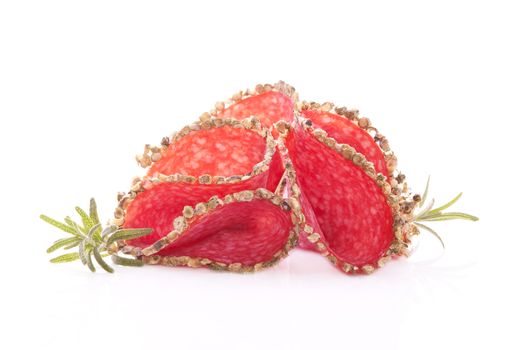 Luxurious salami slices with fresh herbs isolated on white background. Culinary meat eating concept.