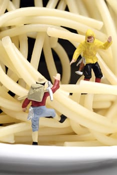 Miniature worker work with spaghetti