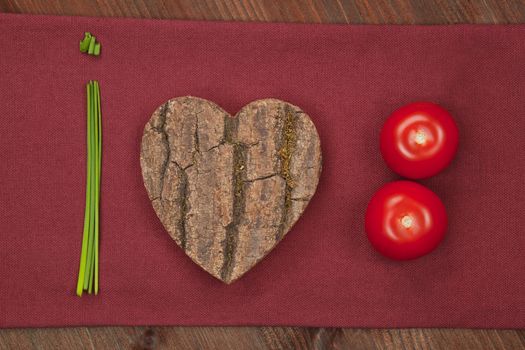 I love vegetable made from chive, wooden heart and fresh tomatoes. Healthy eating background.