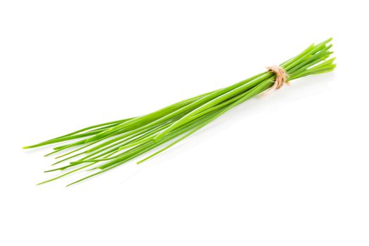 Fresh organic chive bunch bound with brown natural string isolated on white background. Culinary herb concept.