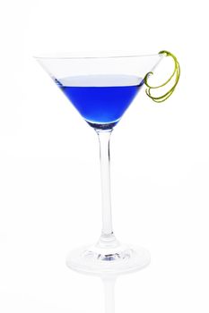 Blue luxurious delicious cocktail with lime garnish in cocktail glass isolated on white background. Fresh summer drink.