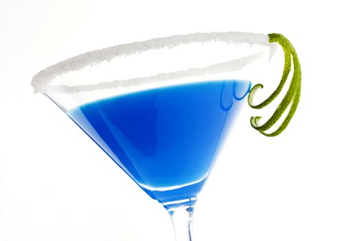 Delicious blue creamy cocktail in cocktail glass isolated on white background. Decorated with lime garnish.