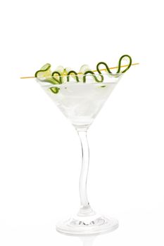 Delicious white cocktail with ice and cucumber garnish in cocktail glass isolated on white. Summer drink