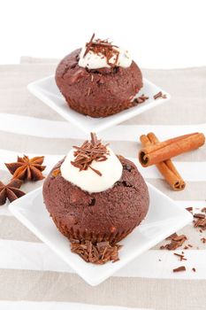 Delicious chocolate muffins with cream and chocolate.