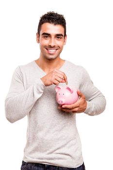 Beautiful man saving money to a piggy bank