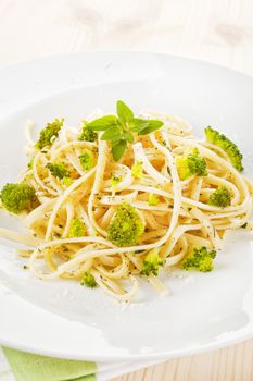 Delicious pasta with broccoli and fresh herbs on white plate. Traditional italian cuisine.