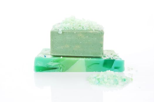 Two different organic green soap bars and bath salt isolated on white background.