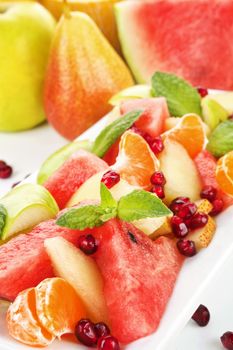 Colorful fruit salad and fruit background. Healthy summer eating. A healthy body is the guest-chamber of the soul; a sick, its prison.  ~Francis Bacon