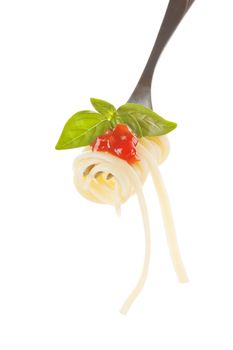 Spaghetti with tomato sauce and basil leaf on silver fork isolated on white. 