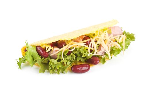 Taco with beans, ham, lettuce and grated cheese isolated on white.